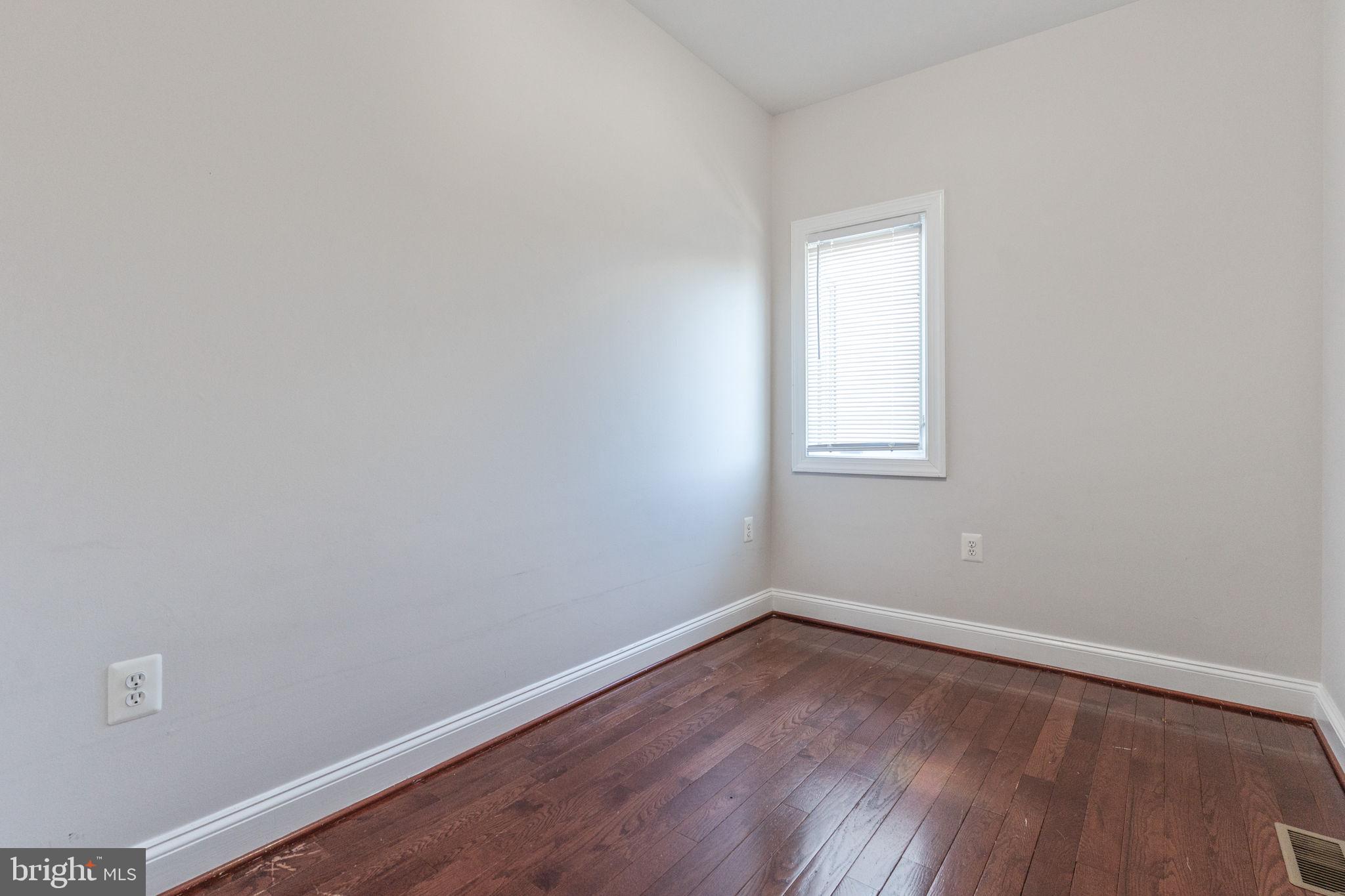 1384 Talbert Court Southeast, Unit A Washington, DC 20020 - Photo 33 of 35 a view of a small space with wooden floor and a window