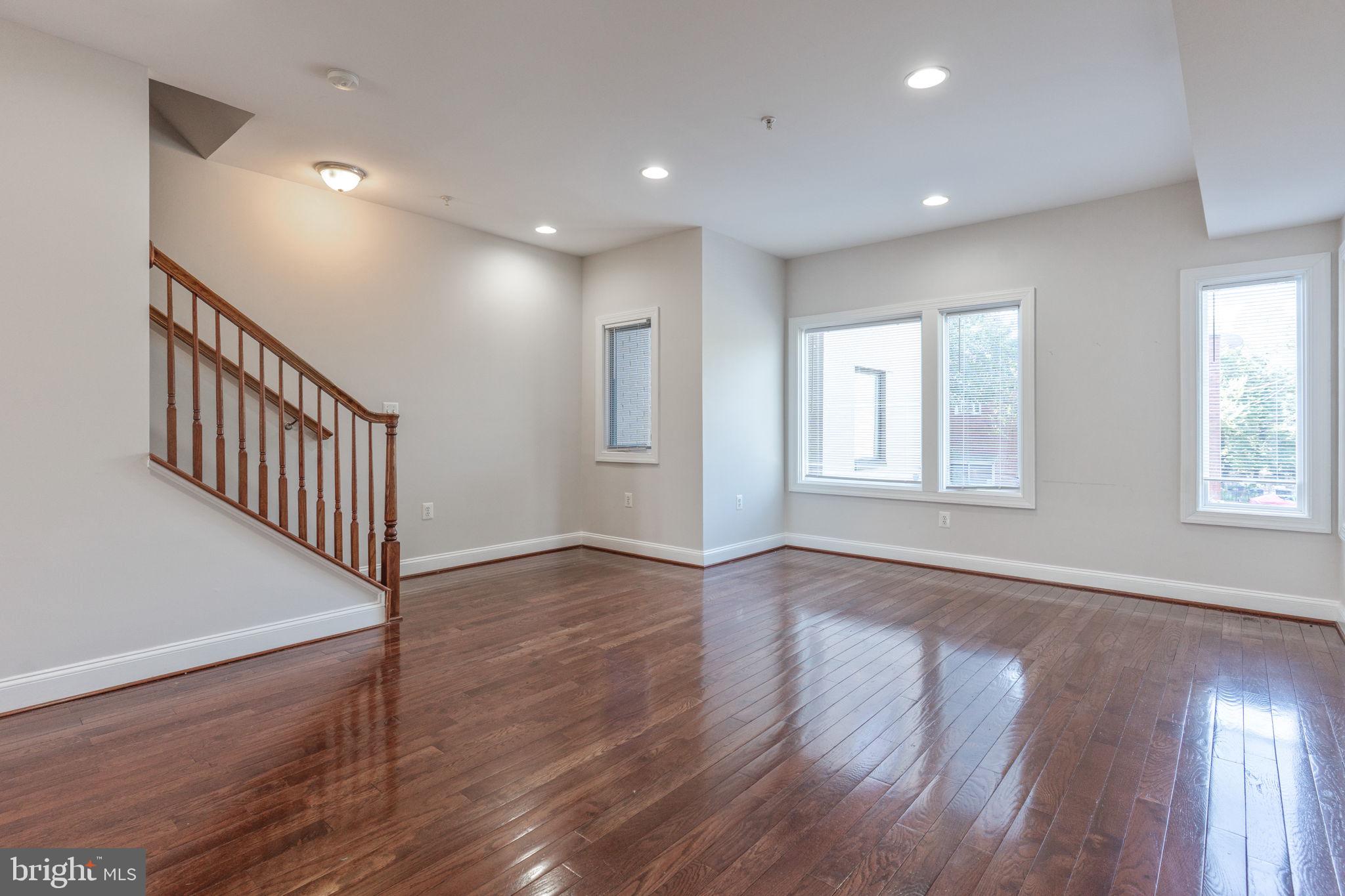 1384 Talbert Court Southeast, Unit A Washington, DC 20020 - Photo 6 of 35 a view of an empty room with wooden floor and a window