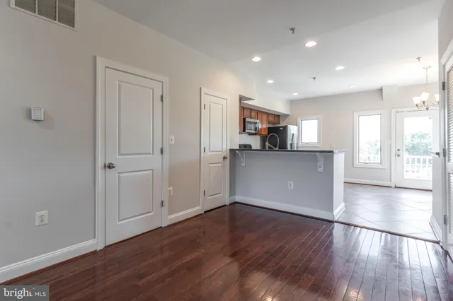 a view of a kitchen with wooden floor and a kitchen