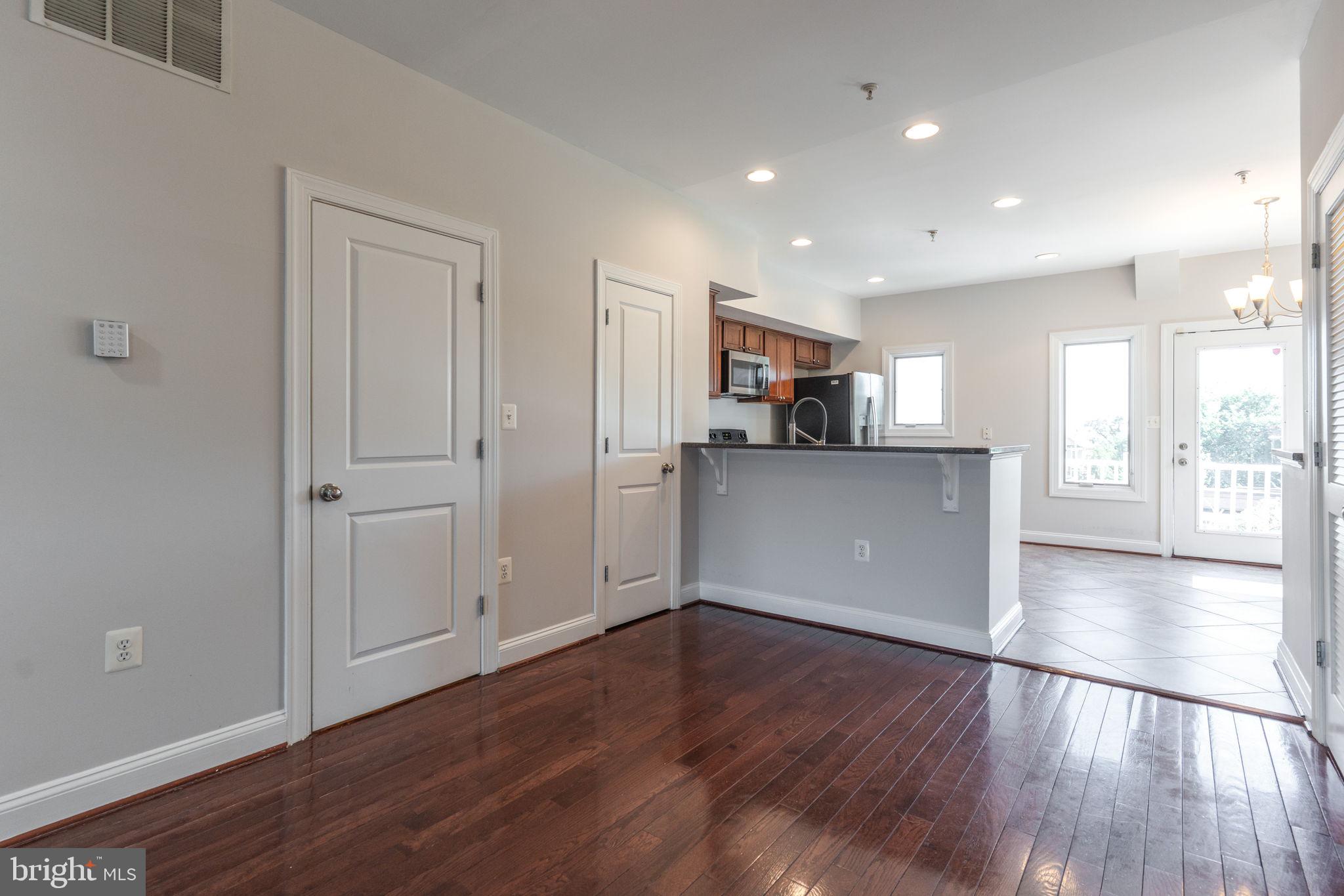 1384 Talbert Court Southeast, Unit A Washington, DC 20020 - Photo 8 of 35 a view of a kitchen with wooden floor and a kitchen