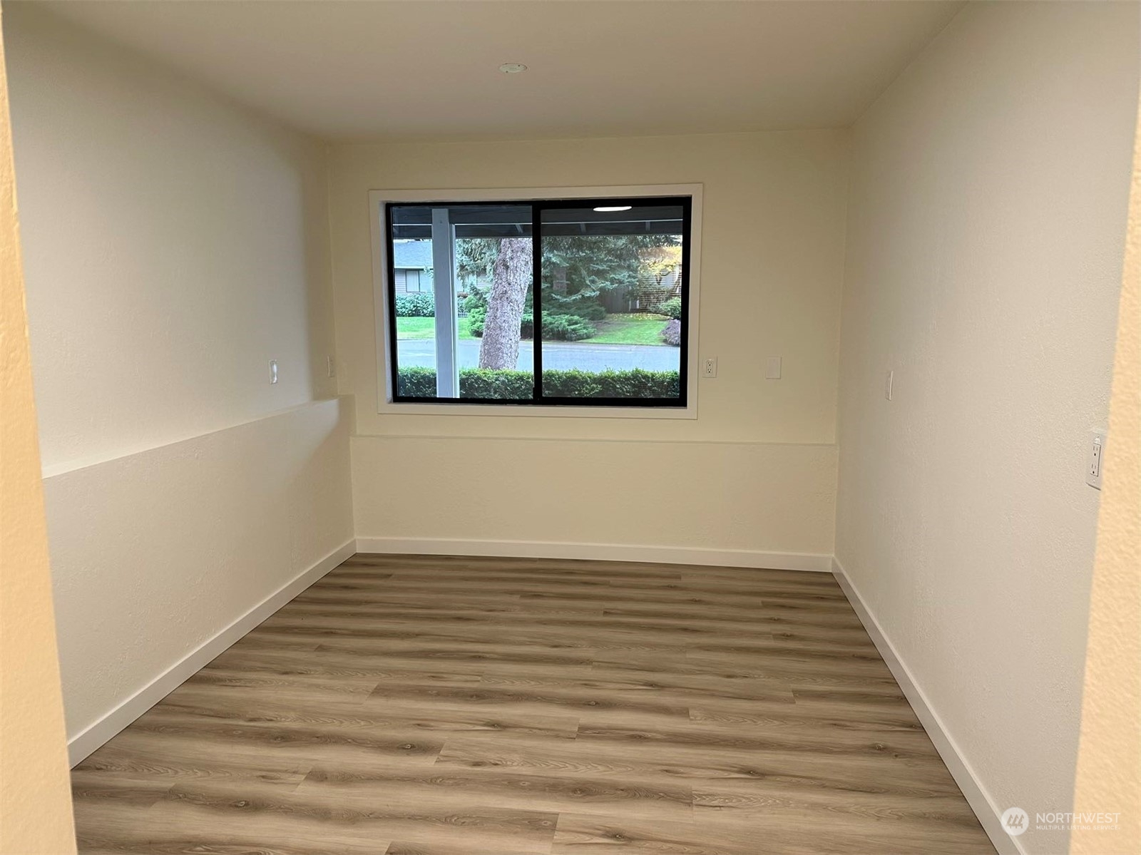 2606 Southwest 340th Place Federal Way, WA 98023 - Photo 11 of 28 a view of an empty room with wooden floor and a window