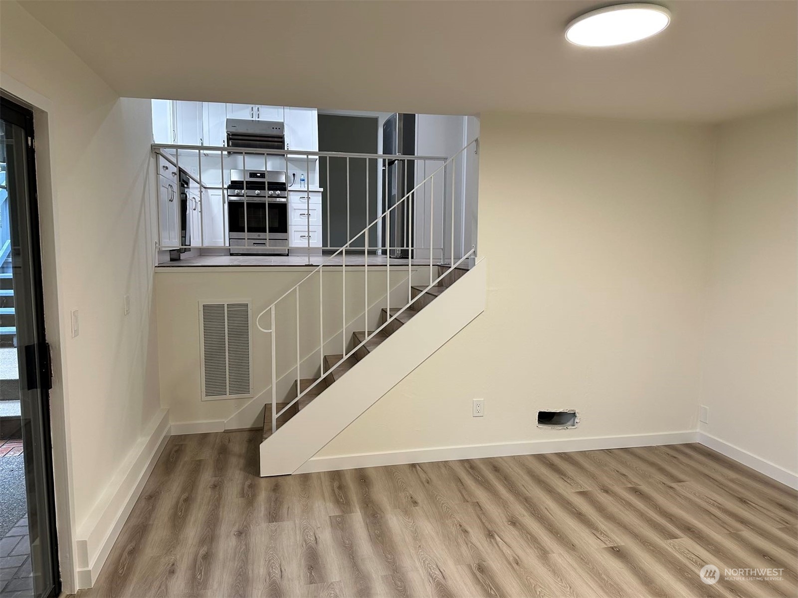 2606 Southwest 340th Place Federal Way, WA 98023 - Photo 14 of 28 a view of a kitchen with wooden floor and staircase