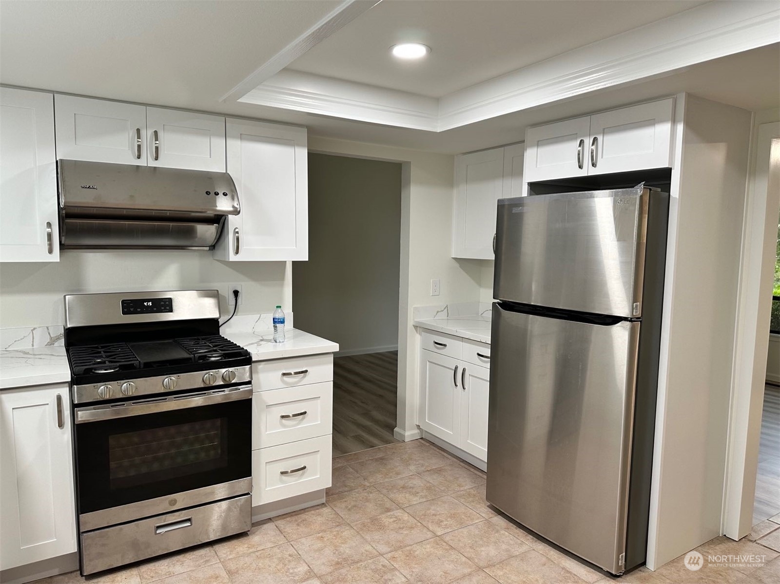 2606 Southwest 340th Place Federal Way, WA 98023 - Photo 6 of 28 a kitchen with stainless steel appliances white cabinets and a stove top oven