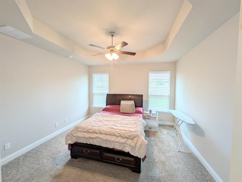 1140 Knightsbridge Road Argyle, TX 76226 - Photo 5 of 13 a bedroom with a bed and a chandelier