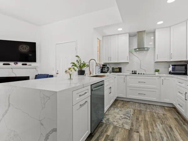 a kitchen with kitchen island white cabinets and white appliances