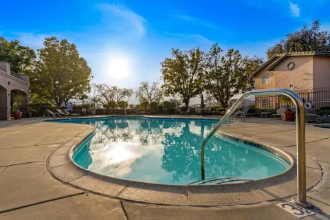 a view of a swimming pool with a yard