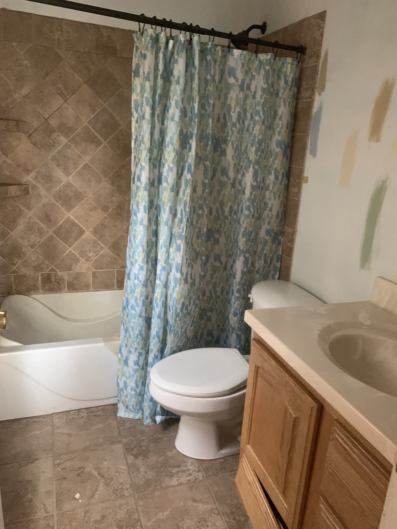 104 Grant Street Harvard, IL 60033 - Photo 10 of 14 a white toilet sitting next to a bath tub