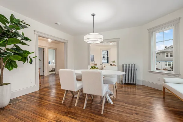 a view of a dining room with furniture window and wooden floor