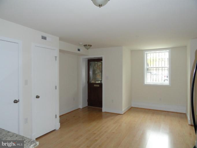1237 Kenyon Street Northwest, Unit A Washington, DC 20010 - Photo 3 of 6 a view of an empty room with closet and a window