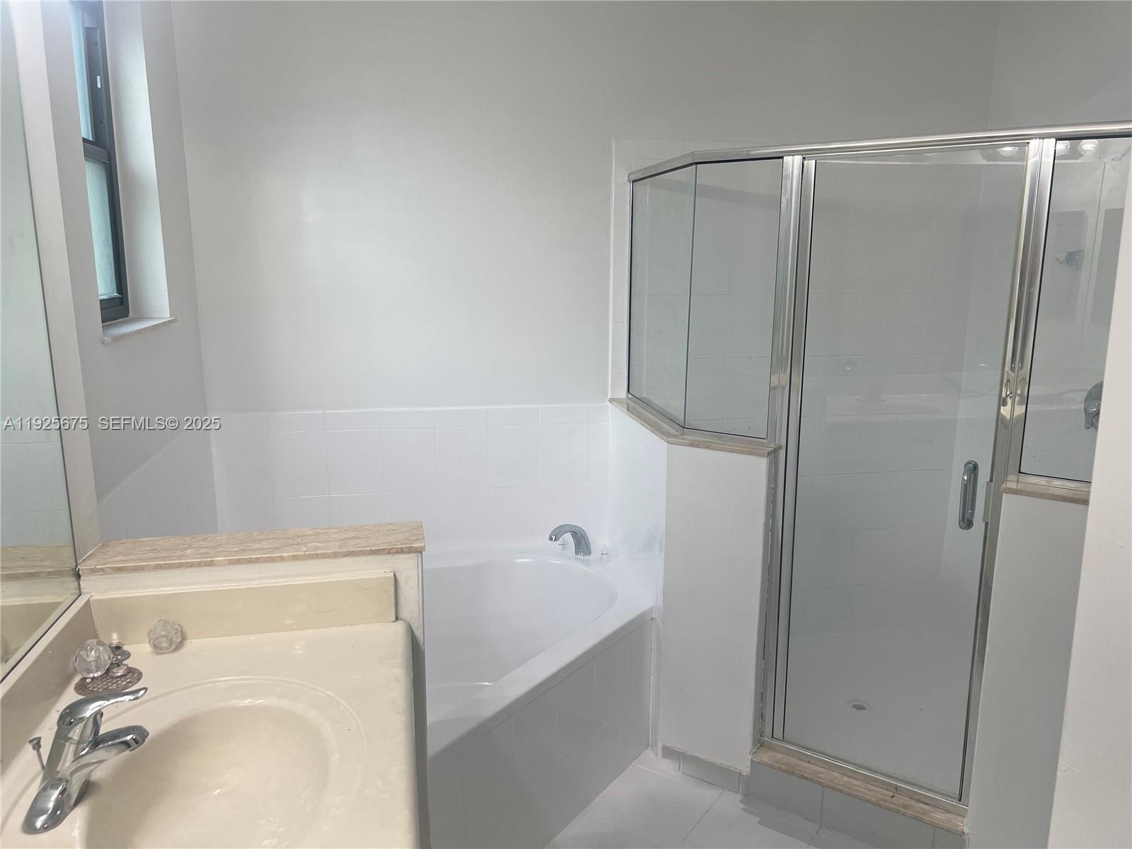 11467 Southwest 238th Street Homestead, FL 33032 - Photo 11 of 16 a bathroom with a bathtub and a sink