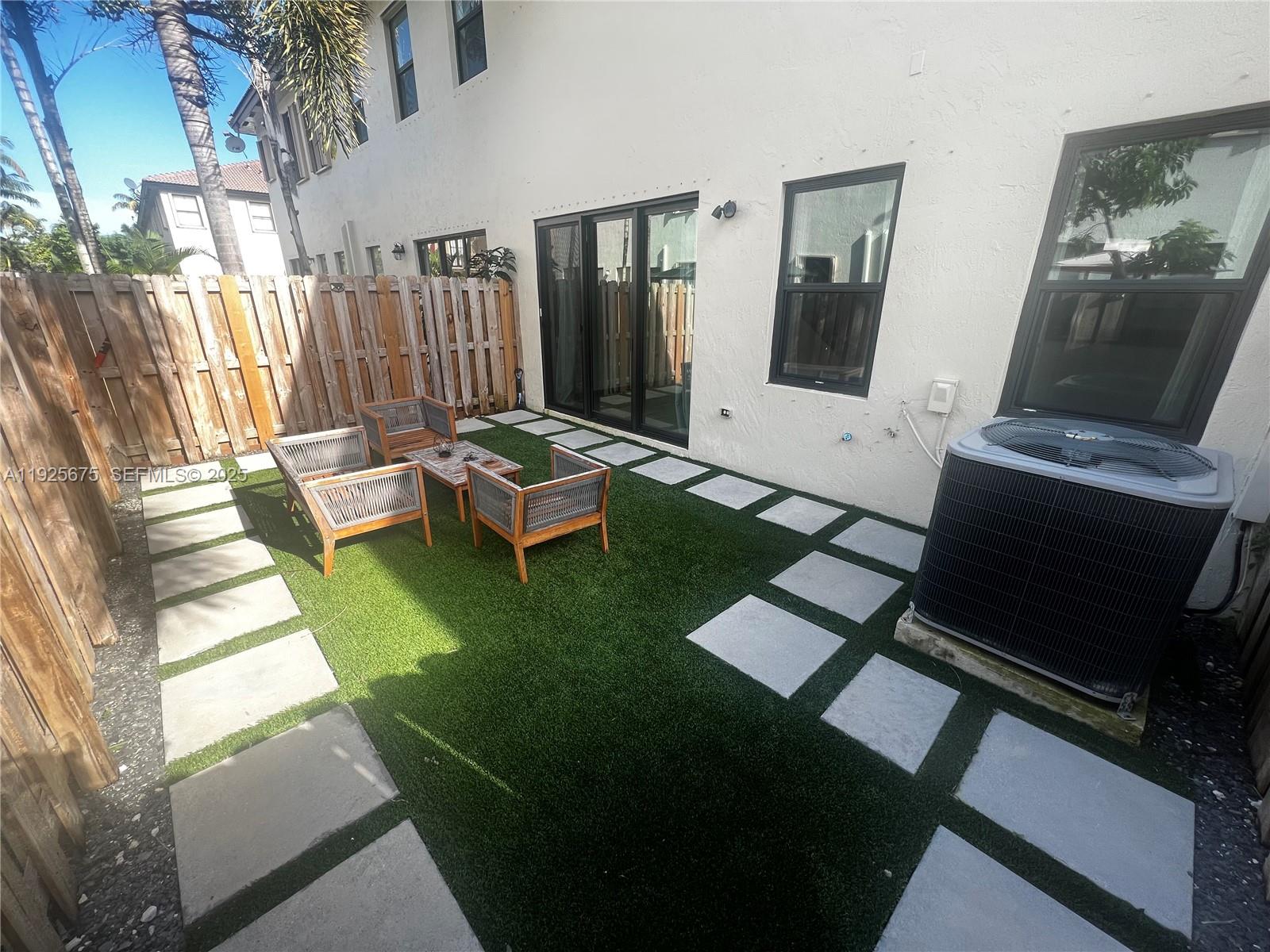 11467 Southwest 238th Street Homestead, FL 33032 - Photo 15 of 16 a living room with chairs and a fireplace