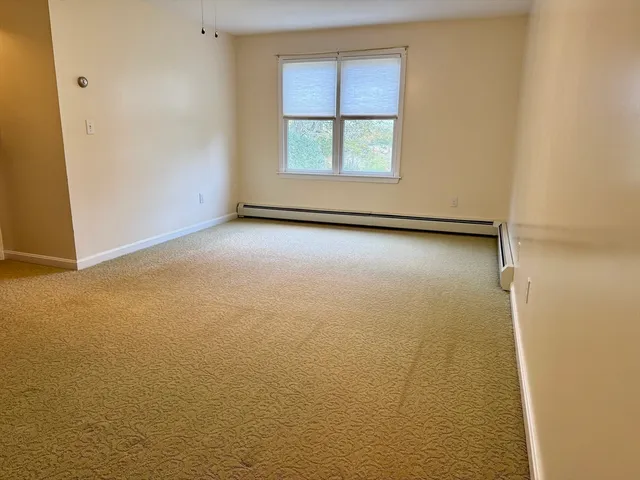 an empty room with a empty space and windows