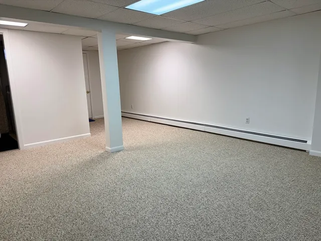 a view of a room with an empty space and a tub