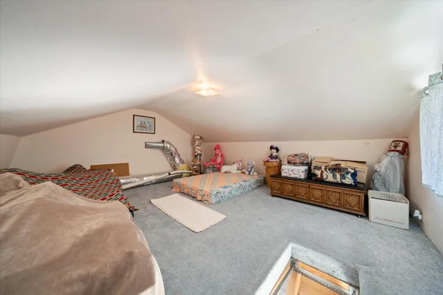a view of a patio with table and chairs and potted plants with wooden fence