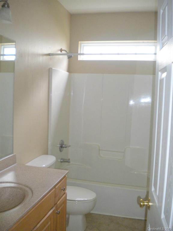 2309 Hargett Road Matthews, NC 28105 - Photo 20 of 24 a bathroom with a granite countertop sink toilet and shower