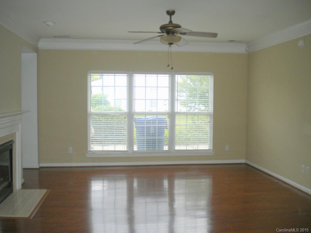 2309 Hargett Road Matthews, NC 28105 - Photo 4 of 24 a view of an empty room with wooden floor and a window