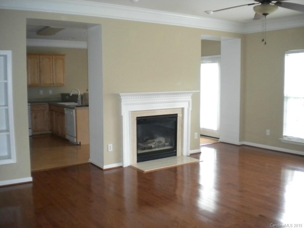 2309 Hargett Road Matthews, NC 28105 - Photo 8 of 24 a view of an empty room with a fireplace and a window
