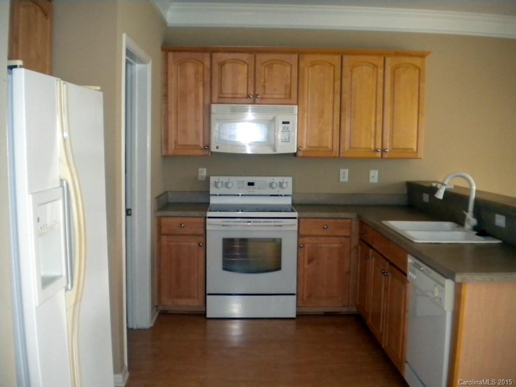 2309 Hargett Road Matthews, NC 28105 - Photo 10 of 24 a kitchen with a sink and a refrigerator