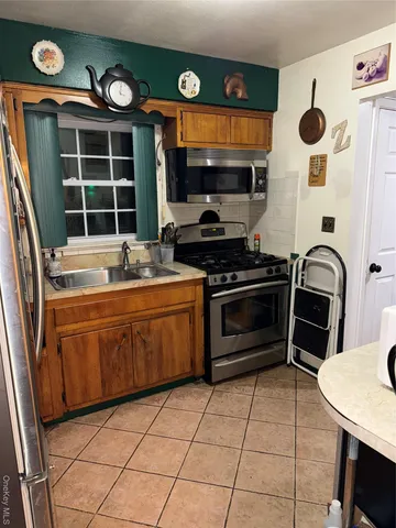 a kitchen with a sink a stove and cabinets