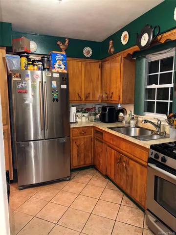 a kitchen with stainless steel appliances granite countertop a refrigerator sink and cabinets