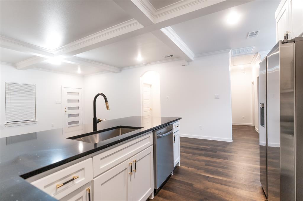 839 Southwest 7th Street Cooper, TX 75432 - Photo 14 of 21 Kitchen featuring visible vents, stainless steel appliances, beamed ceiling, and a sink