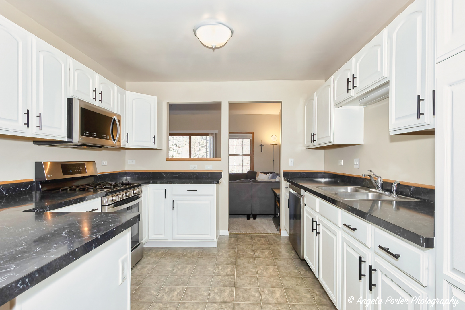5850 Fieldstone Trail McHenry, IL 60050 - Photo 7 of 28 a kitchen with stainless steel appliances granite countertop a stove a sink and a microwave