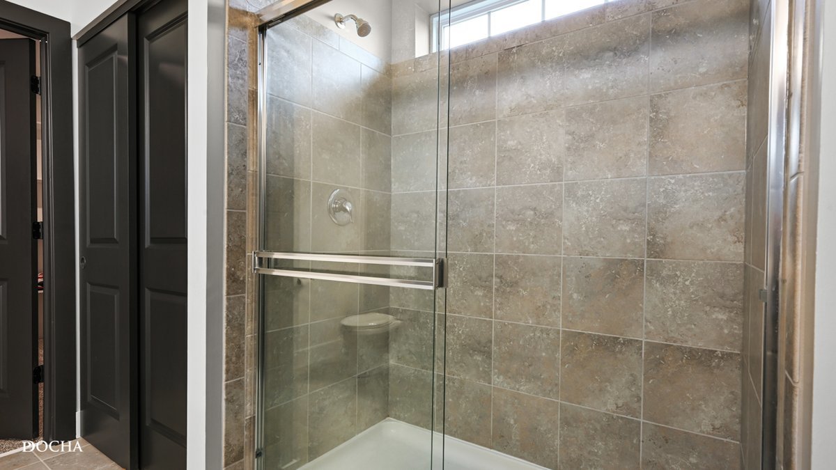 26827 Ashgate Crossing Plainfield, IL 60585 - Photo 12 of 31 a bathroom with a glass shower door