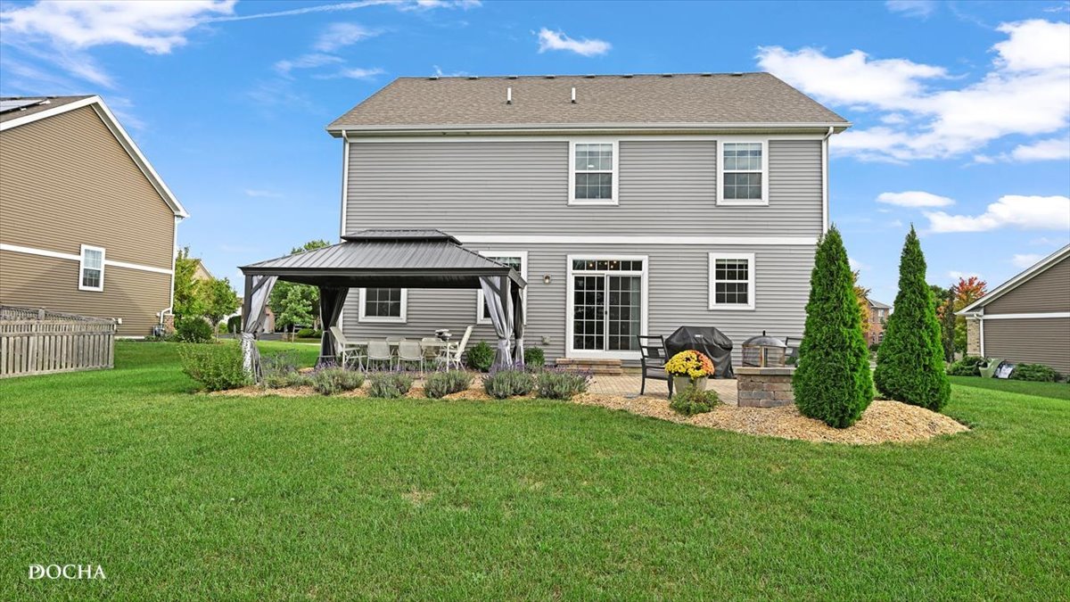 26827 Ashgate Crossing Plainfield, IL 60585 - Photo 28 of 31 a front view of a house with patio and garden