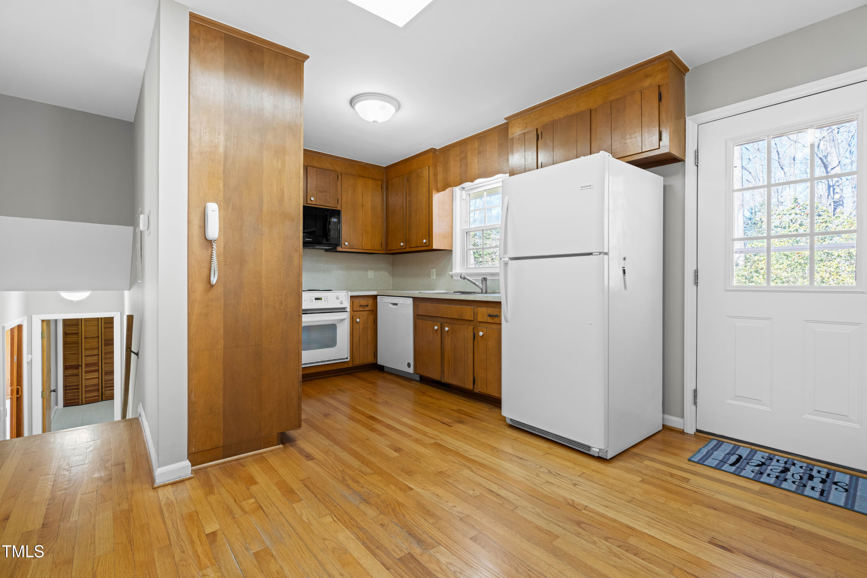 6500 Brandywine Road Raleigh, NC 27607 - Photo 10 of 41 a view of a kitchen with wooden floor and a refrigerator