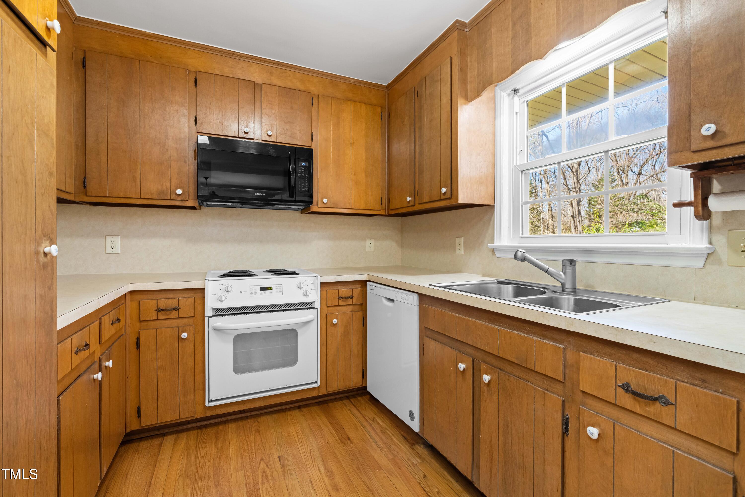 6500 Brandywine Road Raleigh, NC 27607 - Photo 12 of 41 a kitchen with stainless steel appliances a stove microwave and sink