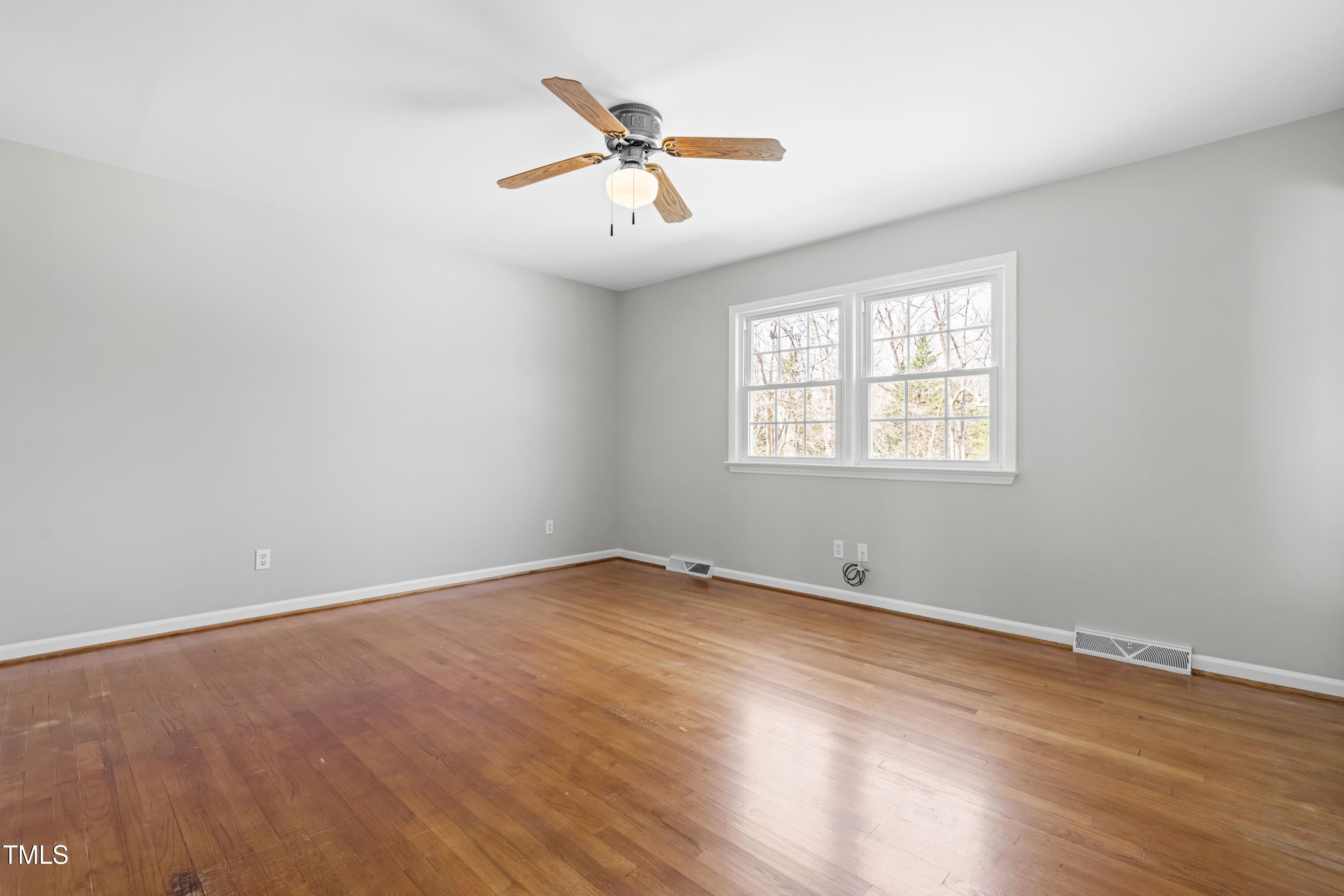 6500 Brandywine Road Raleigh, NC 27607 - Photo 14 of 41 an empty room with wooden floor fan and windows