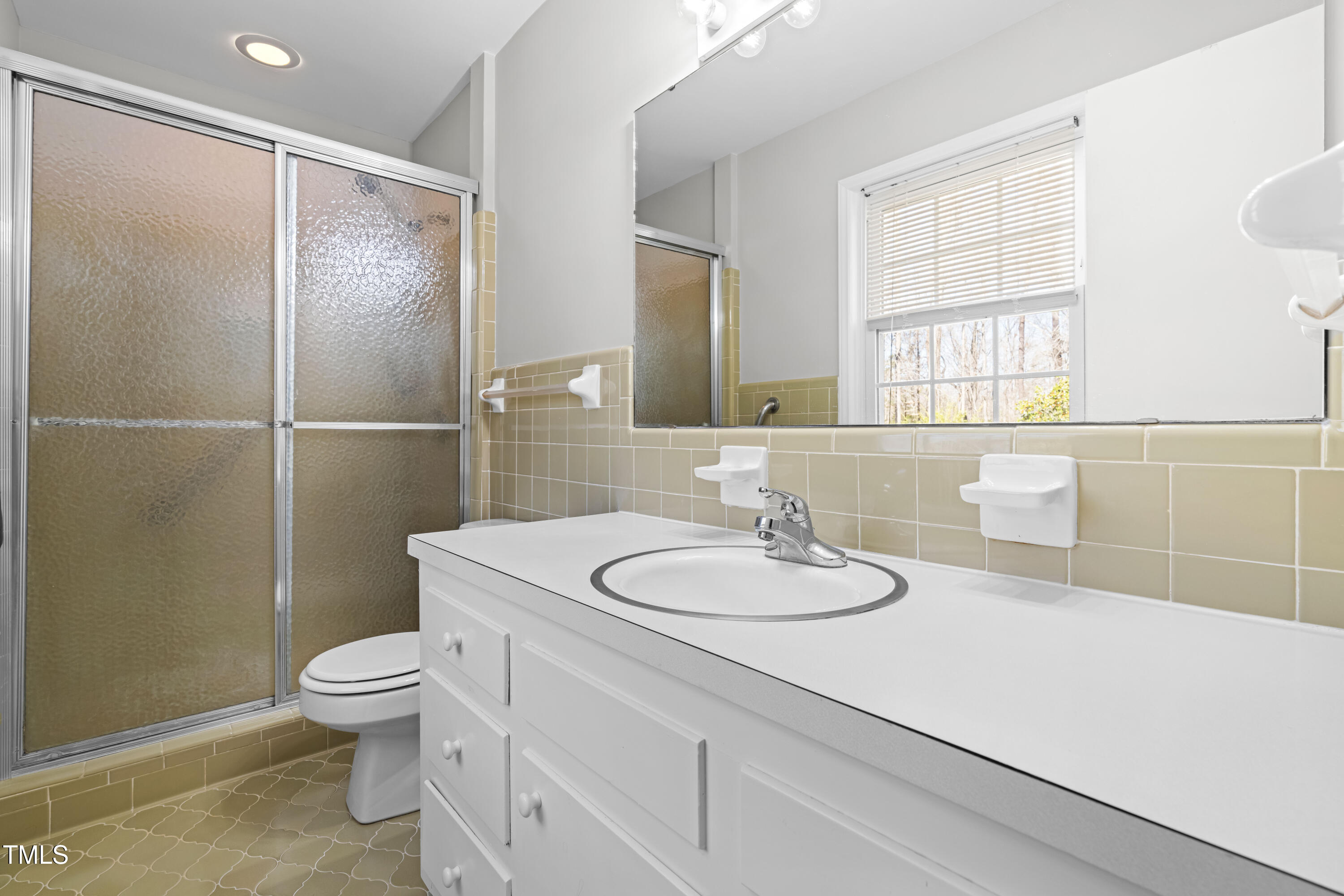 6500 Brandywine Road Raleigh, NC 27607 - Photo 15 of 41 a bathroom with a sink toilet and shower
