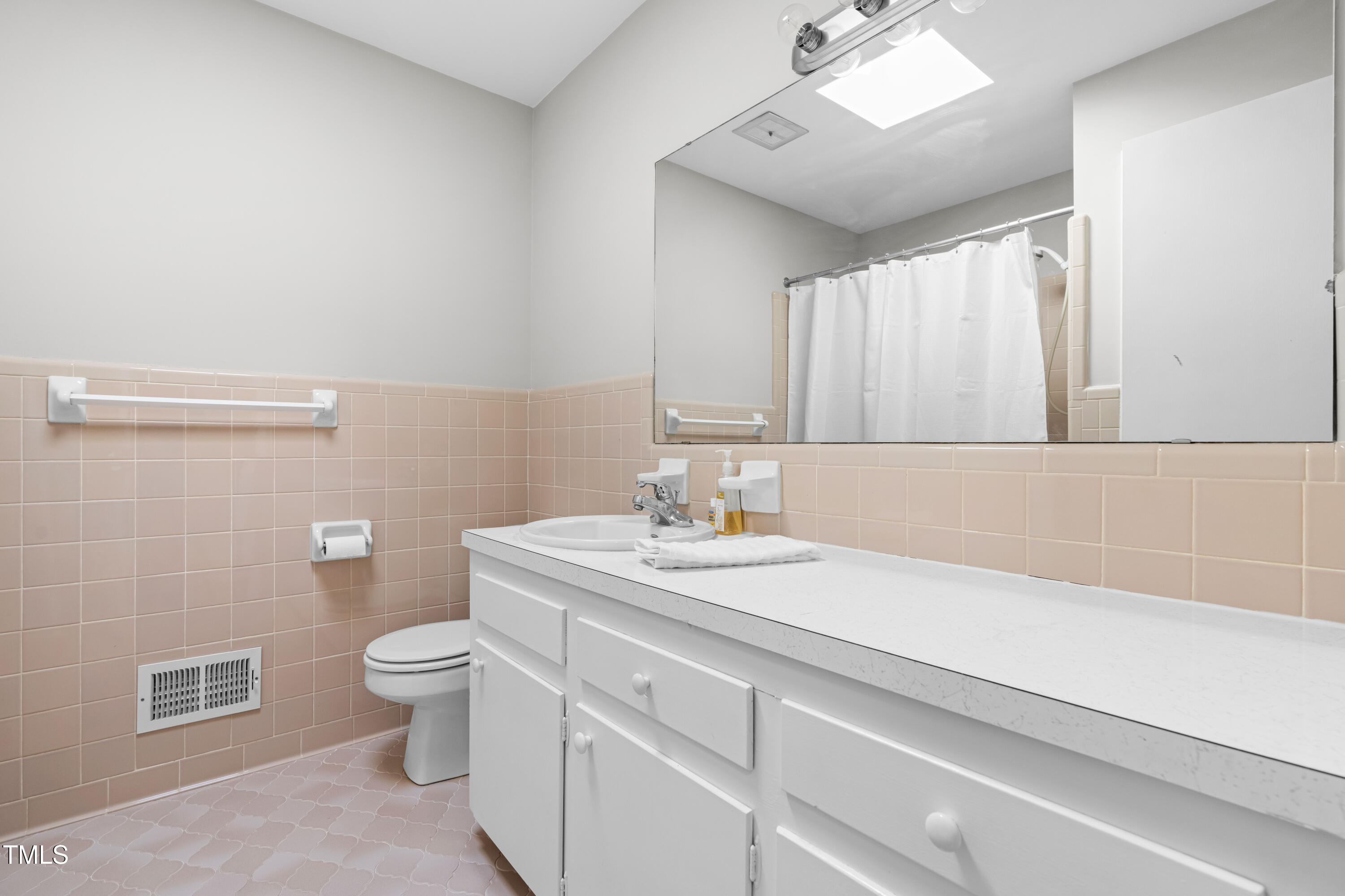 6500 Brandywine Road Raleigh, NC 27607 - Photo 17 of 41 a bathroom with a granite countertop sink a toilet and a mirror
