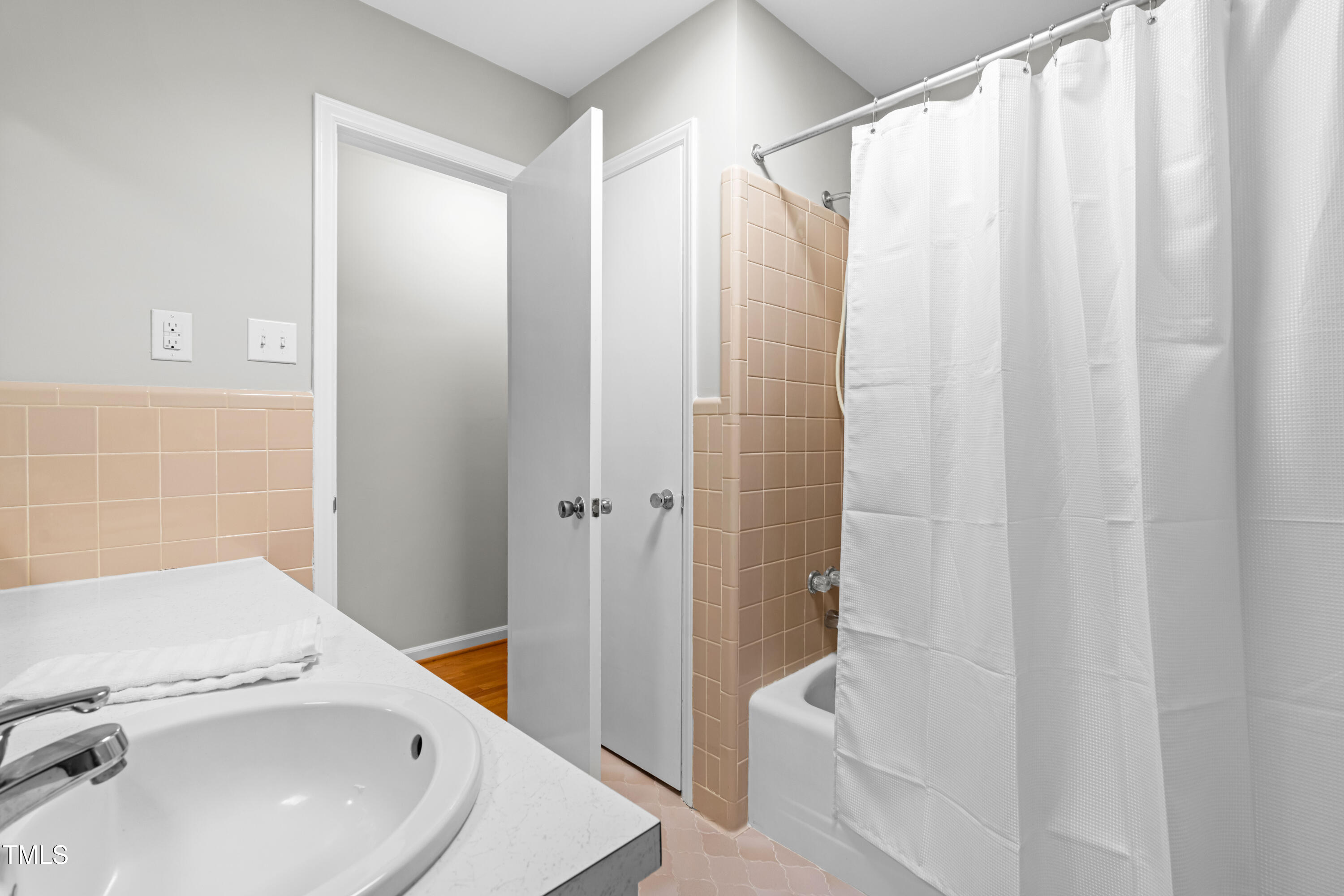 6500 Brandywine Road Raleigh, NC 27607 - Photo 18 of 41 a bathroom with a sink a mirror and a shower