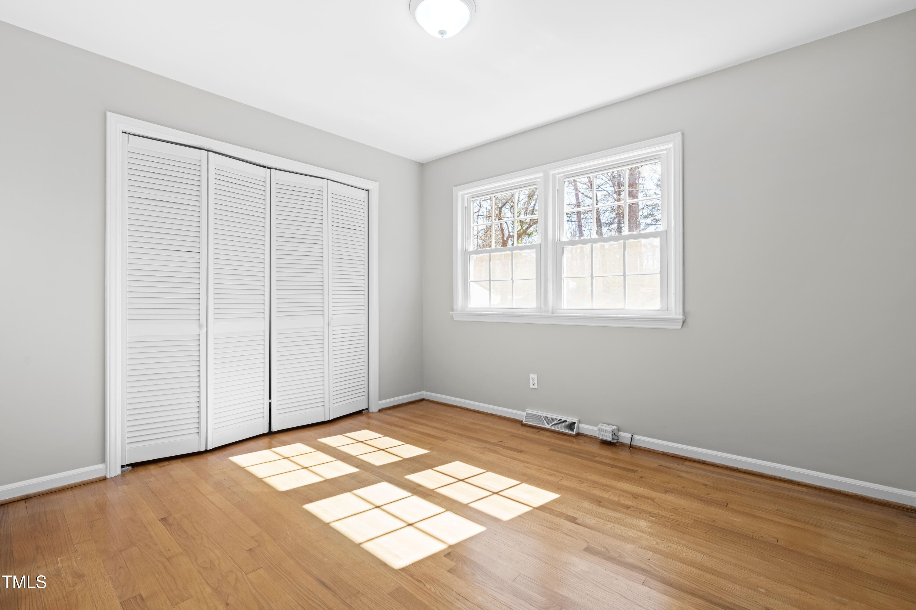 6500 Brandywine Road Raleigh, NC 27607 - Photo 19 of 41 an empty room with wooden floor and windows