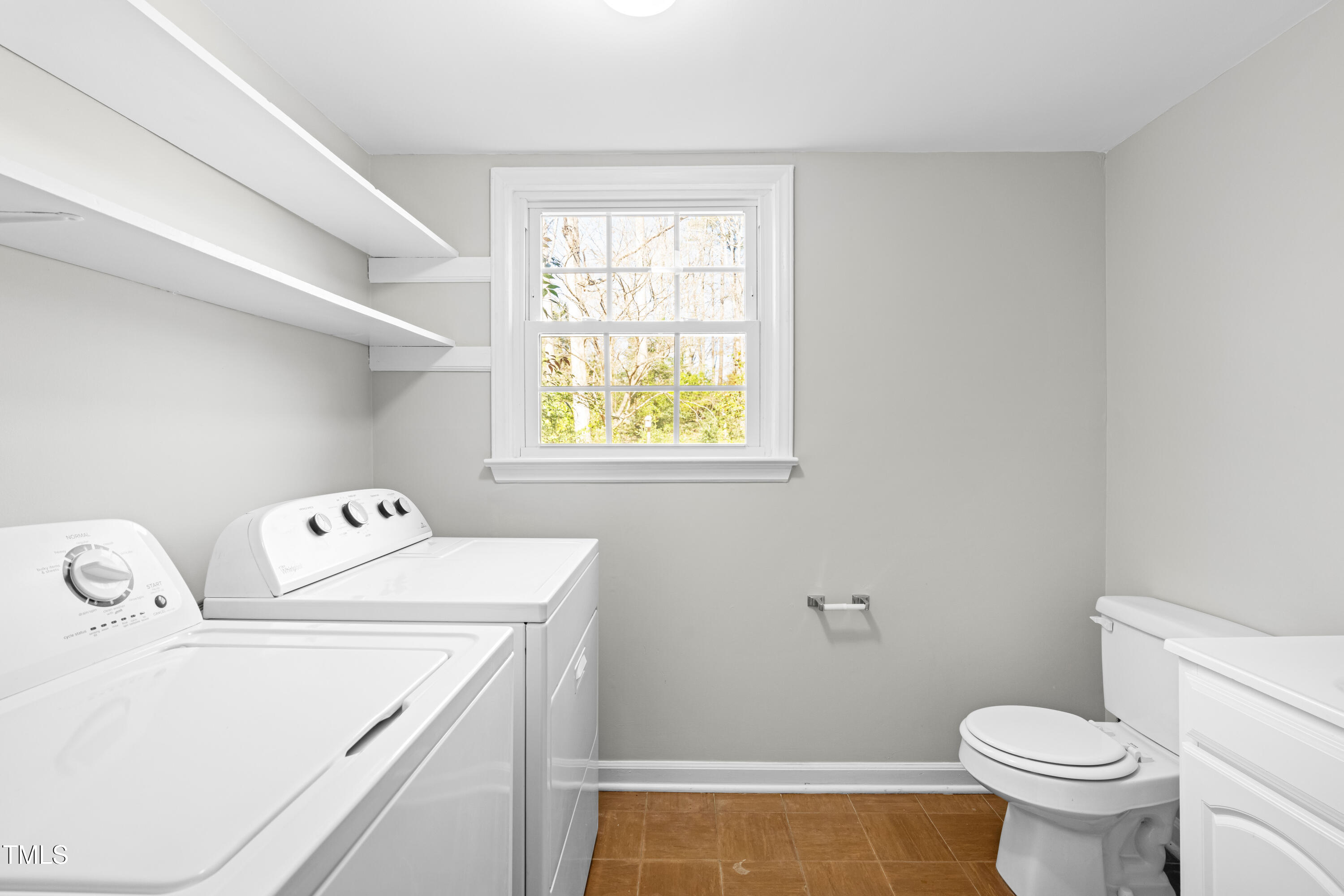6500 Brandywine Road Raleigh, NC 27607 - Photo 20 of 41 a bathroom with a sink a toilet and a window