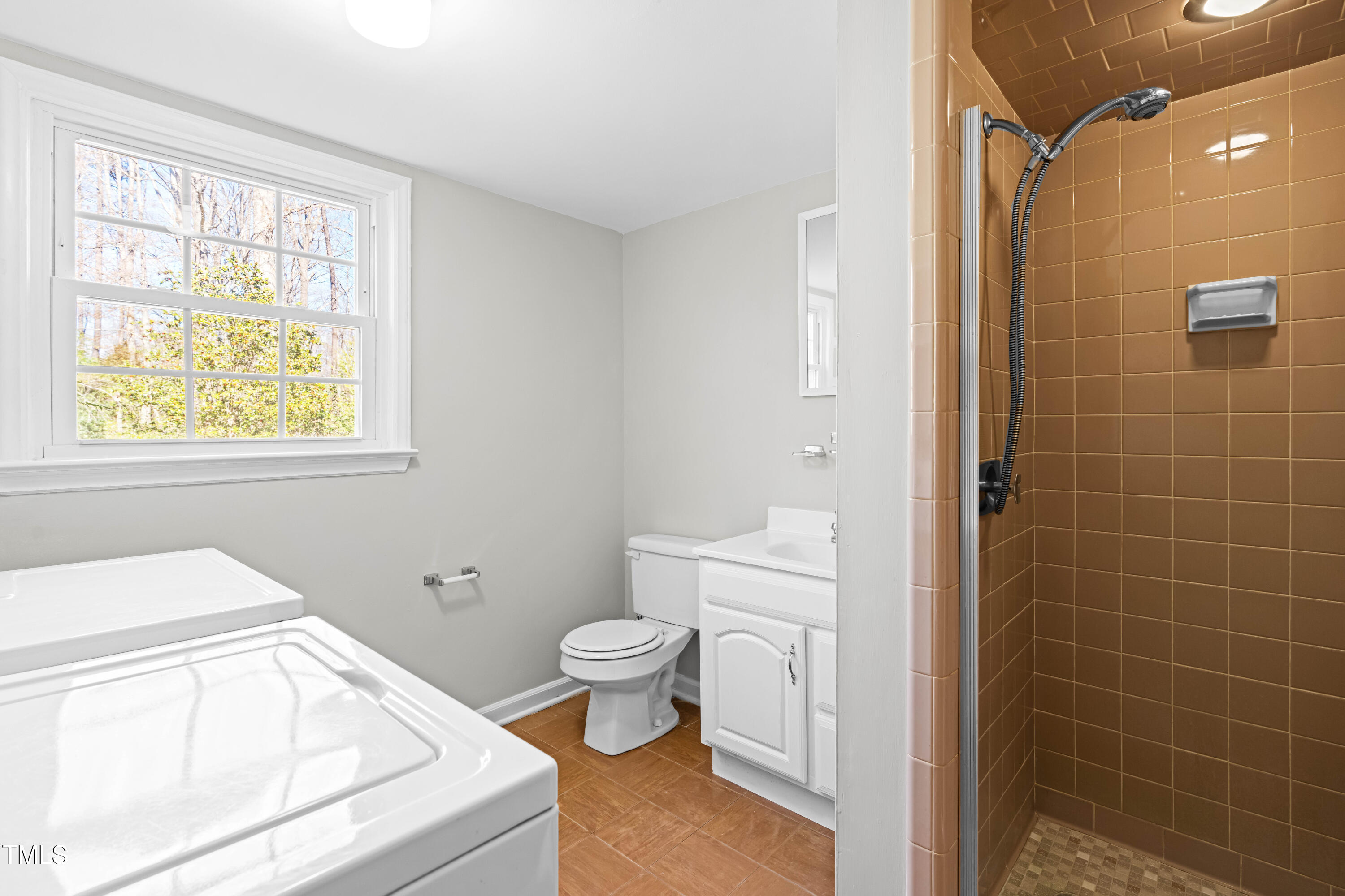 6500 Brandywine Road Raleigh, NC 27607 - Photo 21 of 41 a bathroom with a sink a toilet and shower