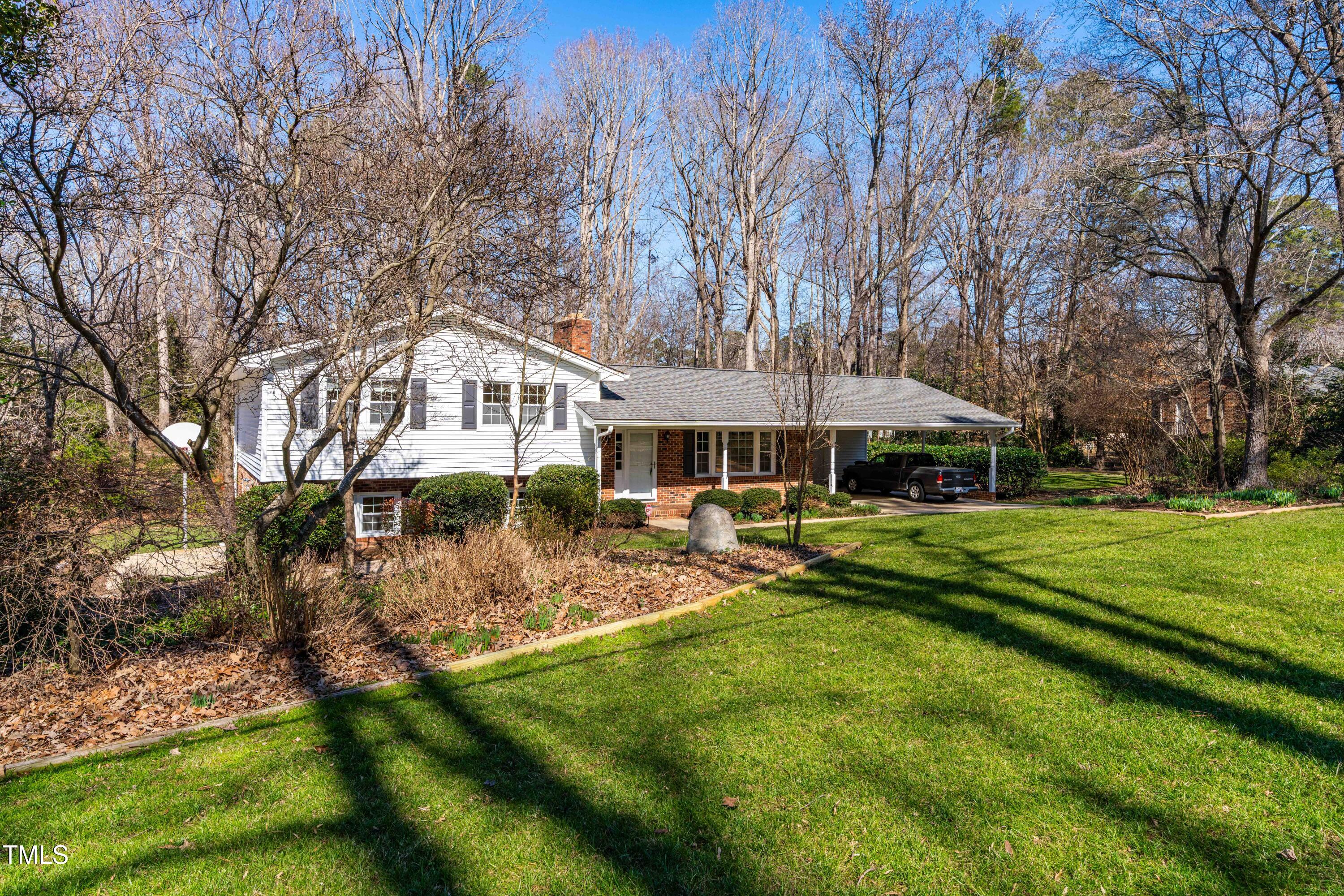 6500 Brandywine Road Raleigh, NC 27607 - Photo 2 of 41 a front view of a house with a yard table and chairs