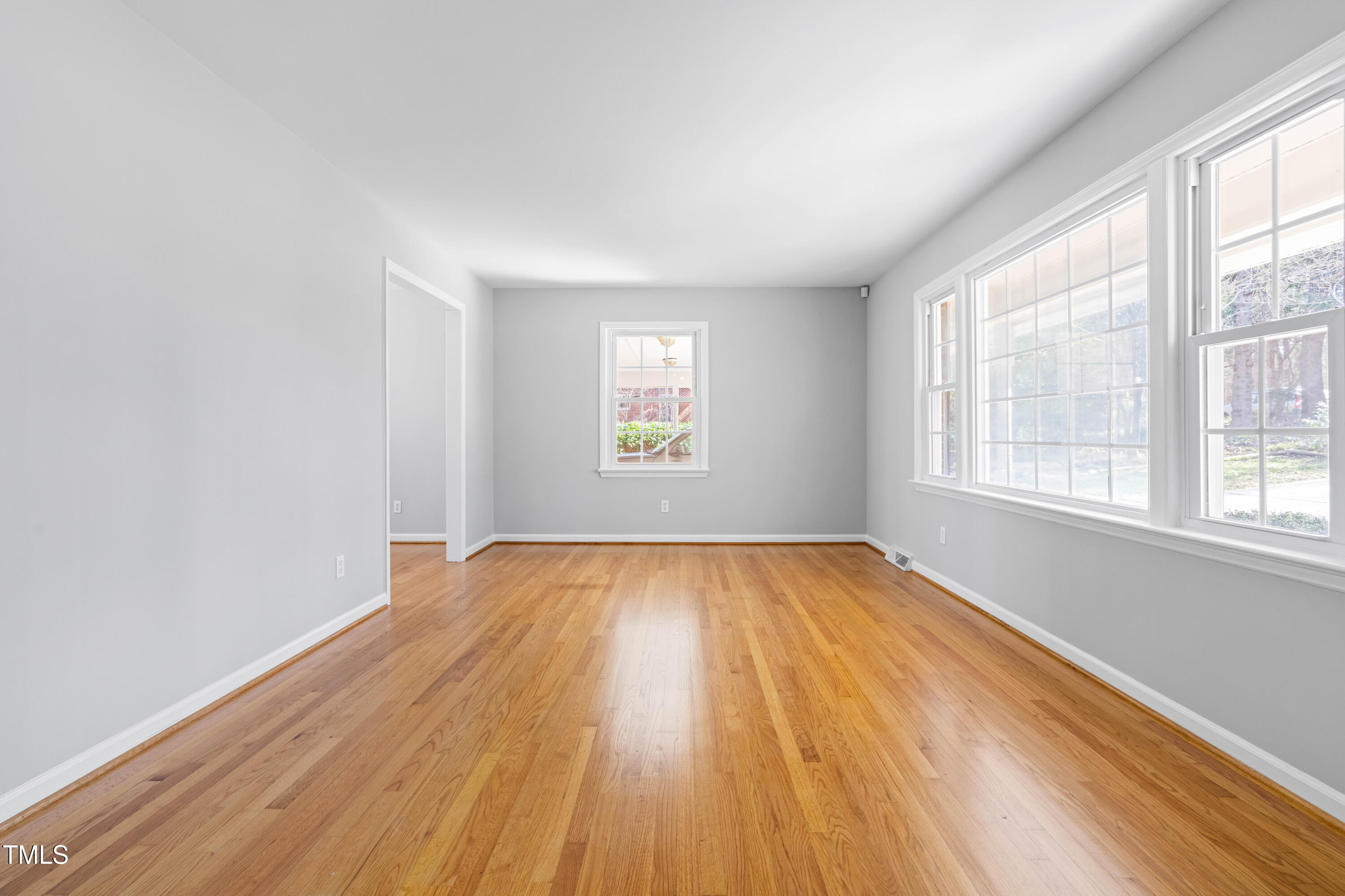 6500 Brandywine Road Raleigh, NC 27607 - Photo 5 of 41 an empty room with wooden floor and windows