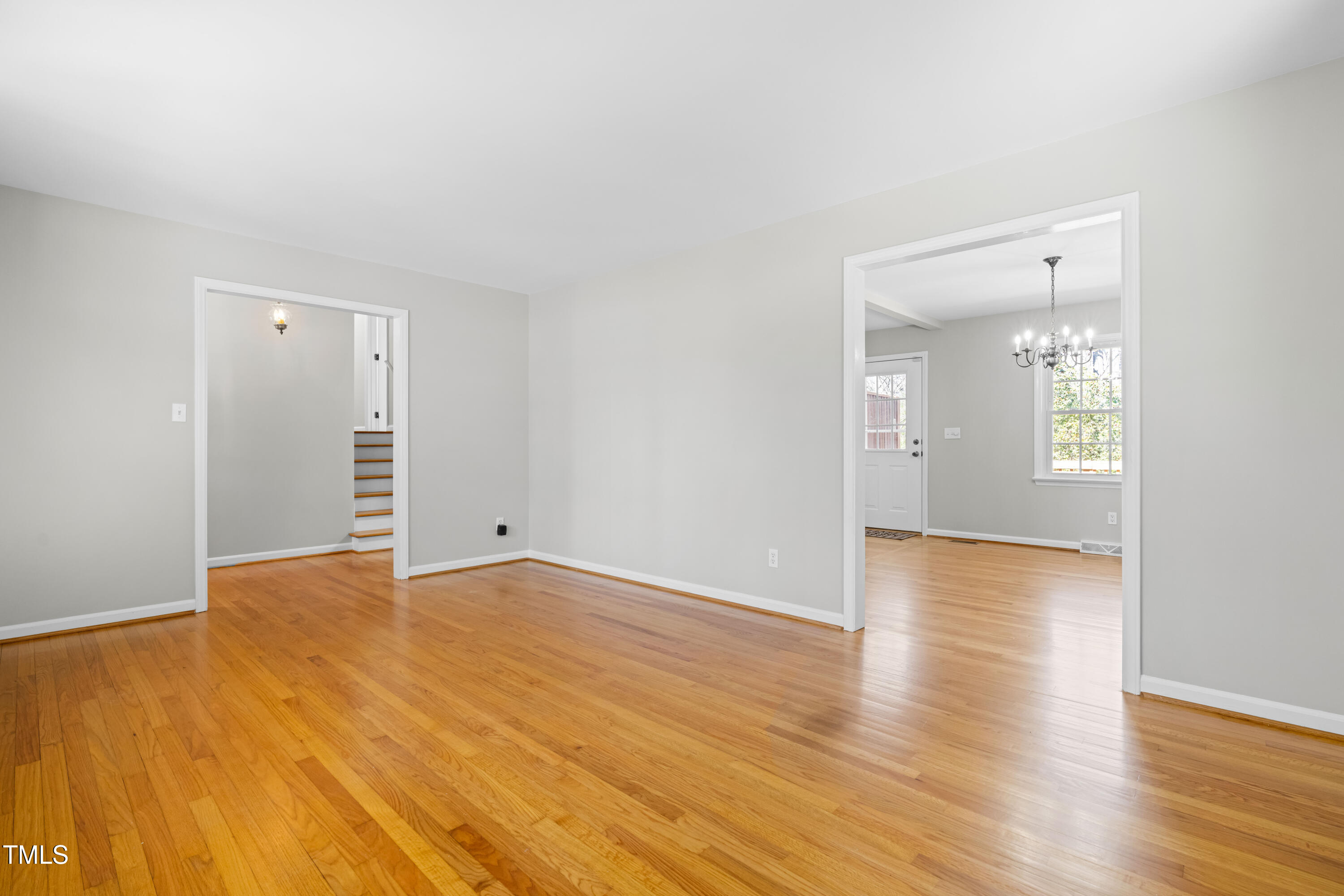 6500 Brandywine Road Raleigh, NC 27607 - Photo 6 of 41 a view of an empty room with wooden floor and a window