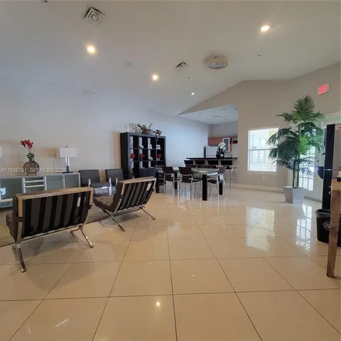 a living room with furniture a dining table and kitchen view