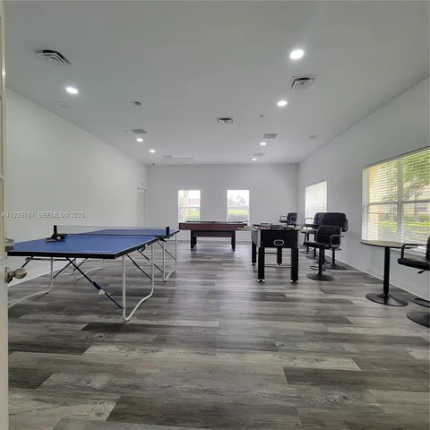a view of dining room with furniture and wooden floor