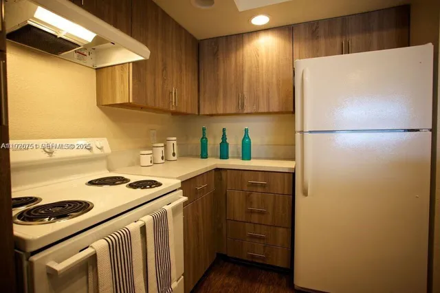 a kitchen with a refrigerator and a stove