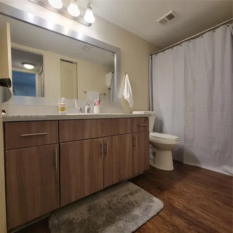 a bathroom with a sink toilet and a mirror