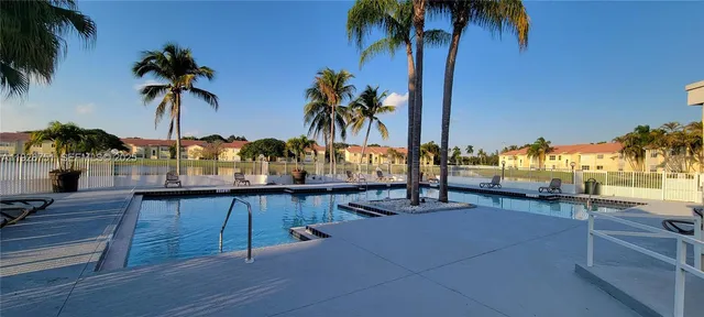 a view of a swimming pool with a table and chairs