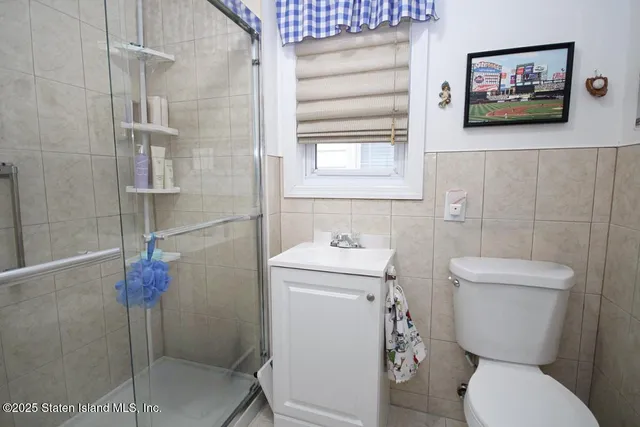a bathroom with a toilet sink and shower