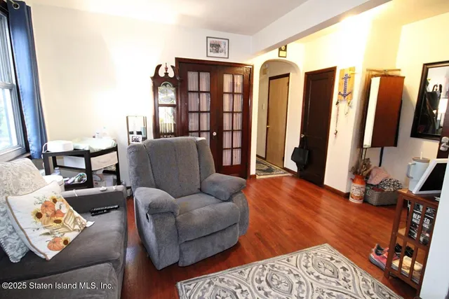 a living room with furniture a rug and a large window
