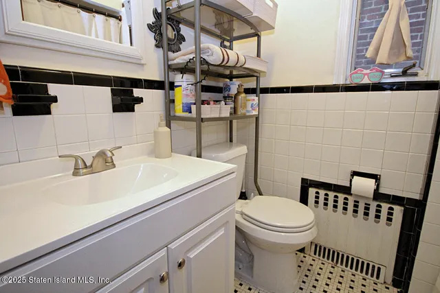 a bathroom with a sink a toilet and mirror