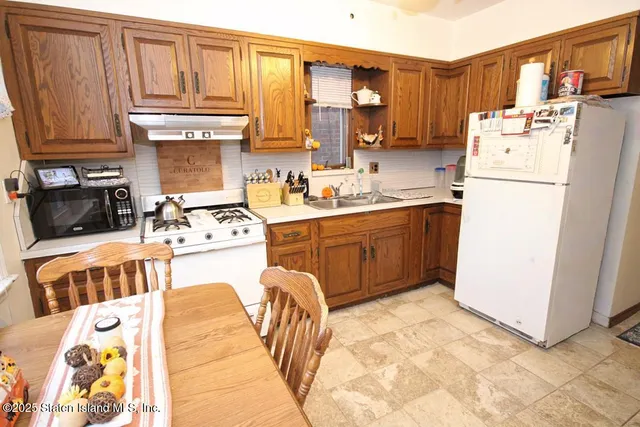 a kitchen with a sink a stove and a refrigerator