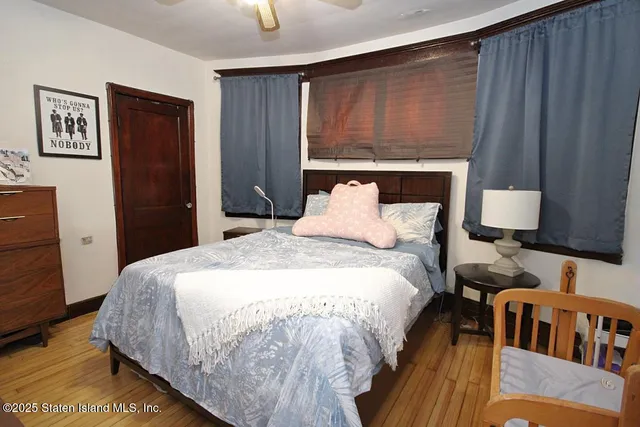 a bedroom with bed and window